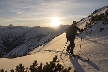 Man with ski pole walking on snowy mountain - MALF00395