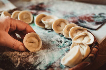 Dumplings with meat in flour on tray - CAVF95963