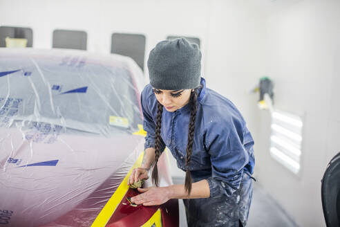 Female Auto worker prepping paint - CAVF96112