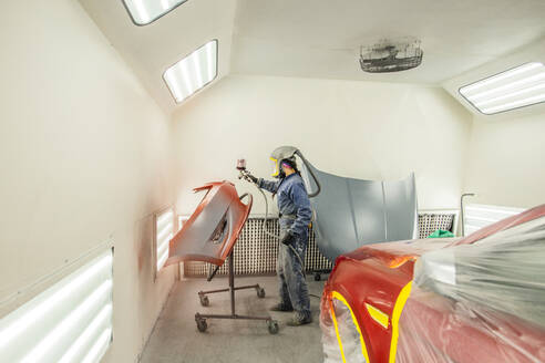 Female Auto worker prepping paint - CAVF96113