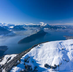 Aerial view of Vierwaldstattersee lake in wintertime with snow, a lake between Switzerland and Italy border. - AAEF14345
