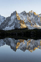 Rocky peaks of Aiguilles de Chamonix reflected in Lacs des Cheserys at sunset, Mont Blanc Massif, Haute Savoie, French Alps, France, Europe - RHPLF21755