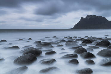 Dark clouds over Uttakleiv beach and stones washed by sea, Leknes, Vestvagoy, Nordland, Lofoten Islands, Norway, Scandinavia, Europe - RHPLF21761