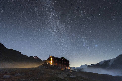 Illuminated mountain hut hotel under the stars, Fluhalp, Zermatt, Valais Canton, Switzerland, Europe - RHPLF21823