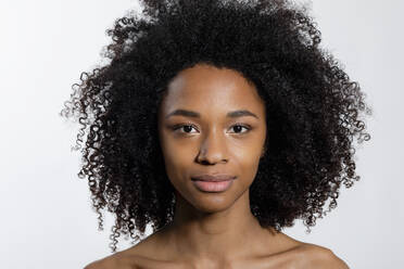 Young woman with curly hair against white background - EIF03639