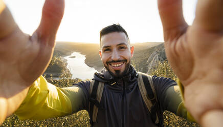 Male hiker taking selfie in Monfrague National Park - JCCMF05869
