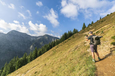 Male hiker taking photos in Karwendel range - FOF13053