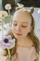 Cute girl holding fresh flower in hand - SEAF00746