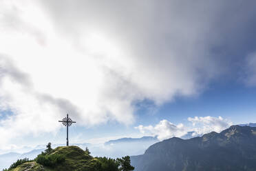 Brunstlkopf summit cross on mountain under cloudy sky - FOF13078