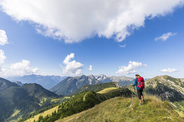 Woman with hiking pole standing on mountain - FOF13087