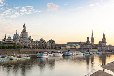 Germany, Saxony, Dresden, Elbe river at dusk with moored tourboats and Dresden Academy of Fine Arts in background - EGBF00850