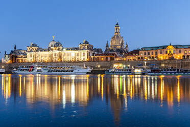 Germany, Saxony, Dresden, Elbe river at dusk with moored tourboats, Frauenkirche and Dresden Academy of Fine Arts in background - EGBF00855