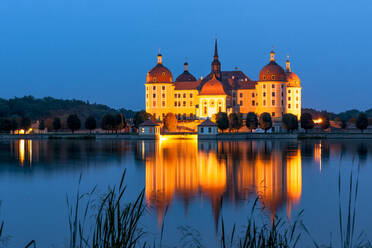 Germany, Saxony, Moritzburg, Long exposure of lake and illuminated Moritzburg Castle at dusk - EGBF00863