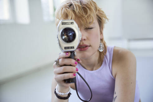 Young woman filming through camera - SUF00677
