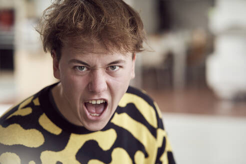 Portrait of angry young man screaming - SUF00710