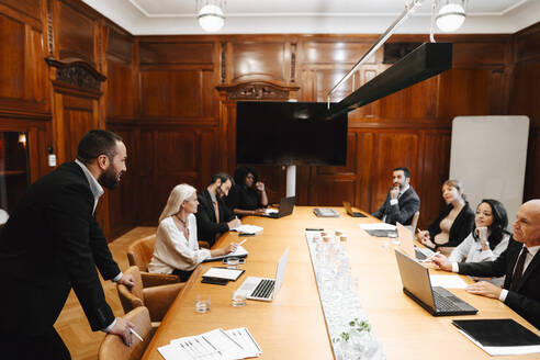 Ein Team aus männlichen und weiblichen Anwälten verschiedener Rassen diskutiert während einer Konferenz im Sitzungssaal - MASF29356