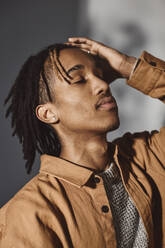 Young man with hand in hair at studio - MASF29685