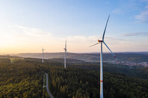 Germany, Baden-Wurttemberg, Aerial view of wind farm turbines in Schurwald range at sunset - WDF06871