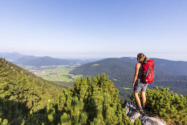 Hiker with backpack looking at mountains - FOF13120