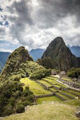 Machu Picchu, the Inca citadel high in the Andes, above the Sacred Valley, plateau with buildings and terraces. - MINF16505