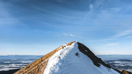 Aerial view of people hiking Le Moleson mountain in winter with snow, Switzerland. - AAEF14368