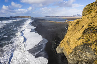 Aerial view of waves rolling on Reynisfjara, a black sand beach along the wild coastline in Iceland. - AAEF14399