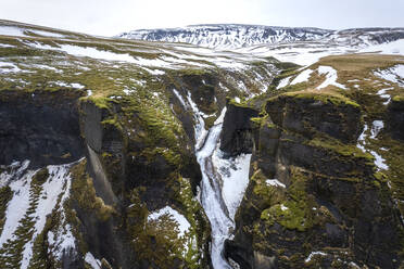 Aerial view of Fjardarargljufur waterfall along the canyon in Iceland. - AAEF14404