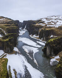 Aerial view of Fjardarargljufur canyon with river in wintertime, Iceland. - AAEF14406