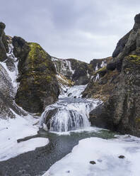 Aerial view of Stjornarfoss waterfall in wintertime in Iceland. - AAEF14407