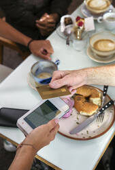 Close-up of man paying with credit card in restaurant - ISF25628