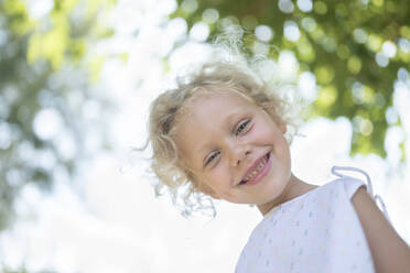 Happy girl with blond hair at garden - SVKF00119