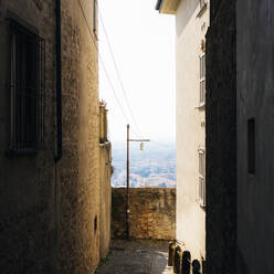 Narrow empty dark alley amidst buildings - GIOF15495