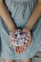 Girl's hands with violet flowers - TYF00132