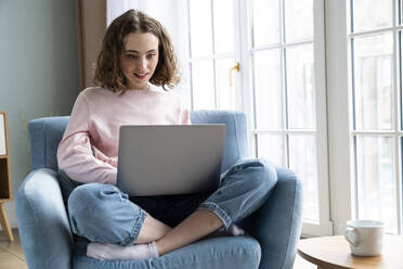 Businesswoman using laptop working at home - VPIF05865