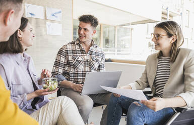 Young business people having a meeting in office with woman sitting in wheelchair - UUF25705