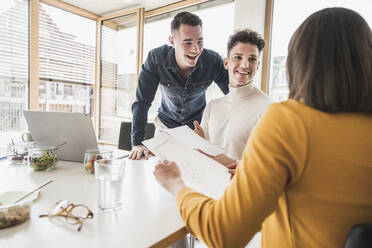 Happy young business people during a meeting in office - UUF25739