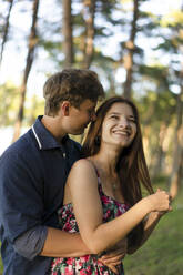 Young man with happy girlfriend in forest - SSGF00750