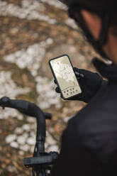 Cyclist checking direction on mobile phone - DMGF00711