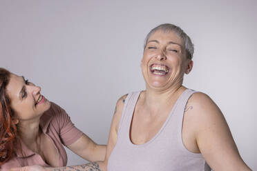 Cheerful friends having fun against white background - EIF04024