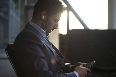 Man sitting in a waiting area going for job interview - CAVF96430