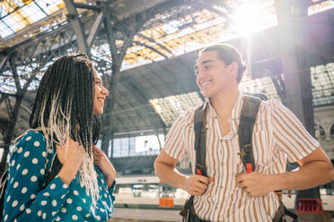 Cheerful diverse couple on railroad station - CAVF96465