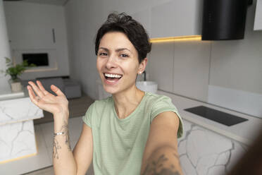 Happy woman taking selfie at home - VPIF06017