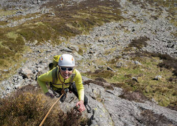 Happy senior woman climbing rock mountain - ALRF01875