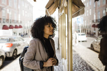 Young woman looking at store window - DCRF01147