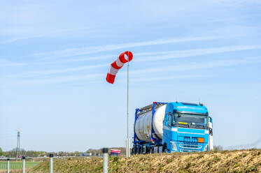 Blauer Tankwagen auf der Autobahn vor einem Windsack - FRF00955