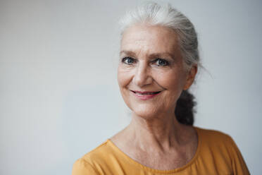 Happy senior woman with gray hair against white background - JOSEF08967