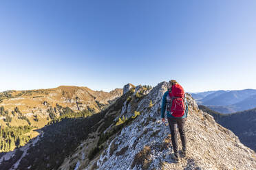 Germany, Bavaria, Female hiker admiring surrounding landscape on way to Hasentalkopf mountain - FOF13169