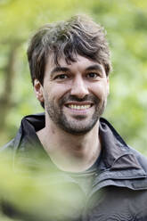 Portrait of happy man in nature - JATF01345