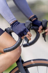Hands of cyclist holding handle of bicycle - OCMF02391