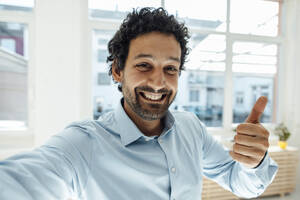 Happy businessman gesturing thumbs up - JOSEF09260